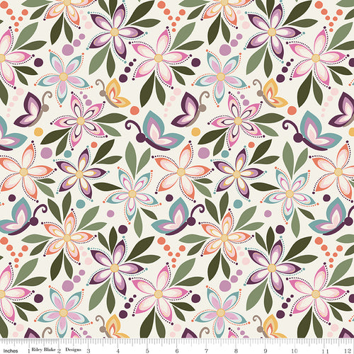 Juju's Petals Floral Cream fabric shown with a ruler for scale, featuring whimsical flowers and butterflies in pink, purple, coral, and teal on cream.