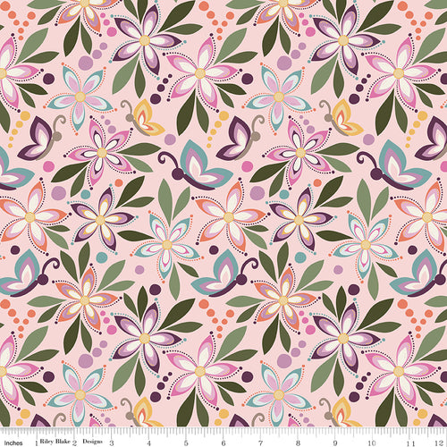 Juju's Petals Floral Pink quilting fabric shown with a ruler for scale, featuring colorful flowers, butterflies, and olive green leaves on a soft pink background.