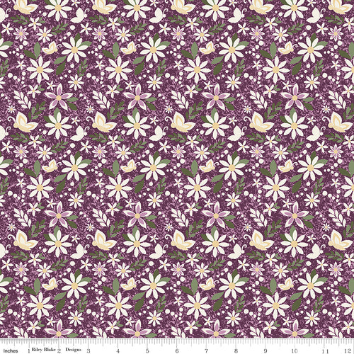 Juju's Petals Dance Purple floral quilting fabric shown with a ruler for scale, featuring cream and pink daisies with green foliage on a purple background.