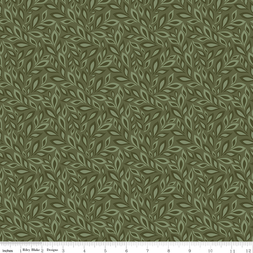 Juju's Petals Leaves Green botanical quilting fabric shown with a ruler for scale, featuring overlapping leafy branches in earthy green tones.