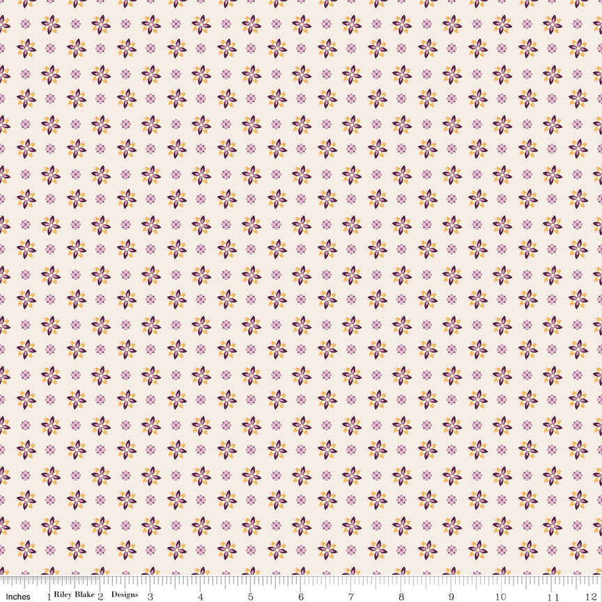 Juju's Petals Calico Cream floral quilting fabric shown with a ruler for scale, featuring rows of colorful small flowers on a light cream background.