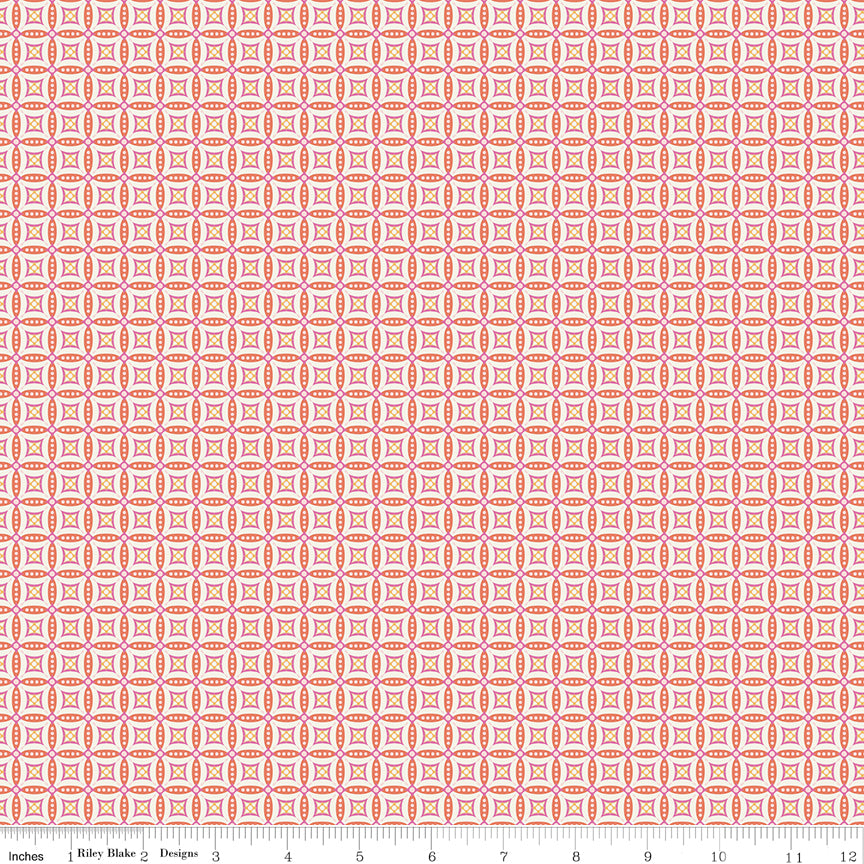 Juju's Petals Mosaic Orange fabric shown with a ruler for scale, featuring small repeating diamond and petal-shaped mosaic motifs.