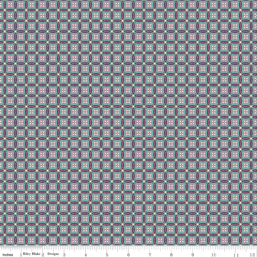 Juju's Petals Mosaic Teal fabric shown with a ruler for scale, featuring small repeating diamond and petal-shaped geometric motifs.