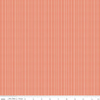 Juju's Petals Dotted Stripe Orange fabric shown with a ruler for scale, featuring narrow vertical rows of white dots and dashes.