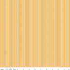Juju's Petals yellow dotted stripe fabric shown with a ruler for scale, featuring narrow vertical rows of white dots on golden yellow.